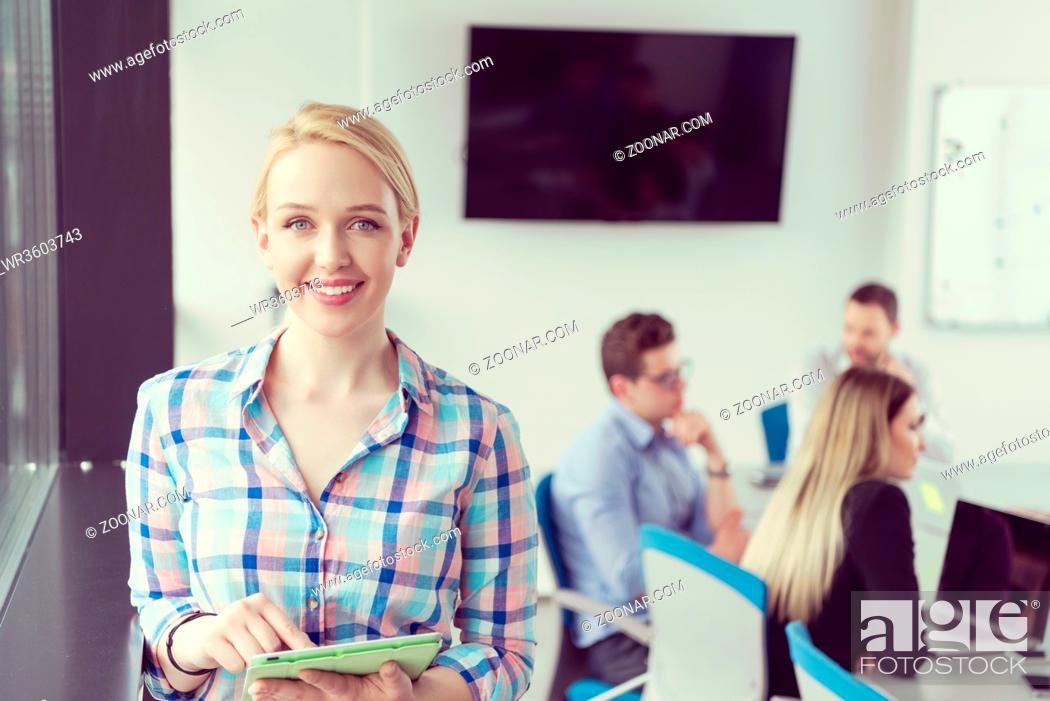 Stock Photo: Business Woman Using Digital Tablet in corporate office by window.