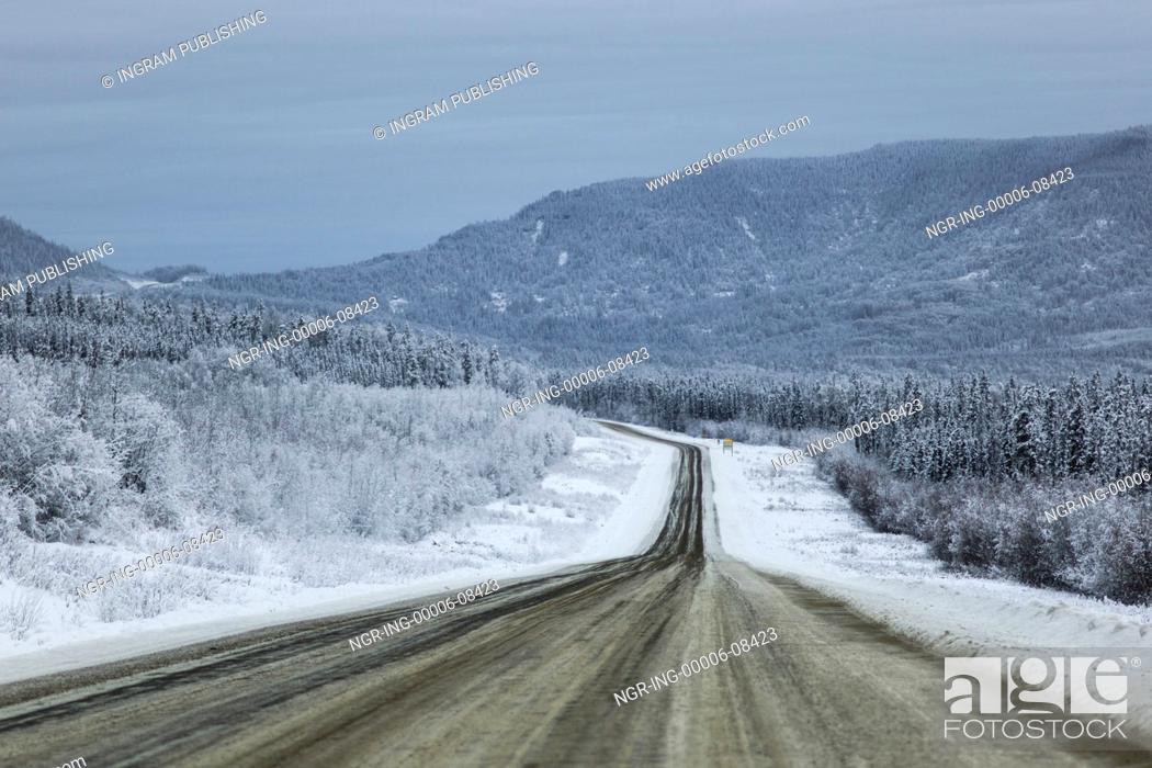 Stock Photo: Highway passing through snow covered forest, Alaska Highway, Northern Rockies Regional Municipality, British Columbia, Canada.