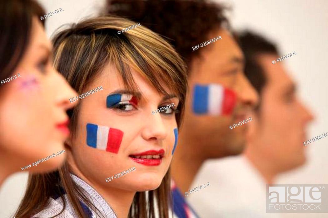 Stock Photo: Friends watching the French team play a soccer game.