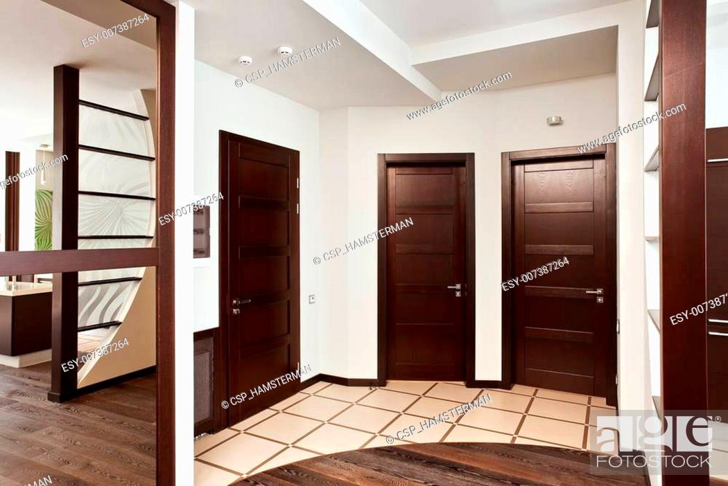 Stock Photo: Modern hall interior with many hardwood doors.
