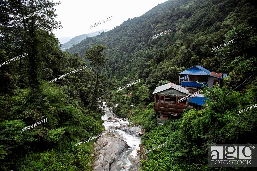 Stock Photo: Typical Himalayan houses near a creek. Annapurna Conservation Area (Nepal), August 21st 2019.