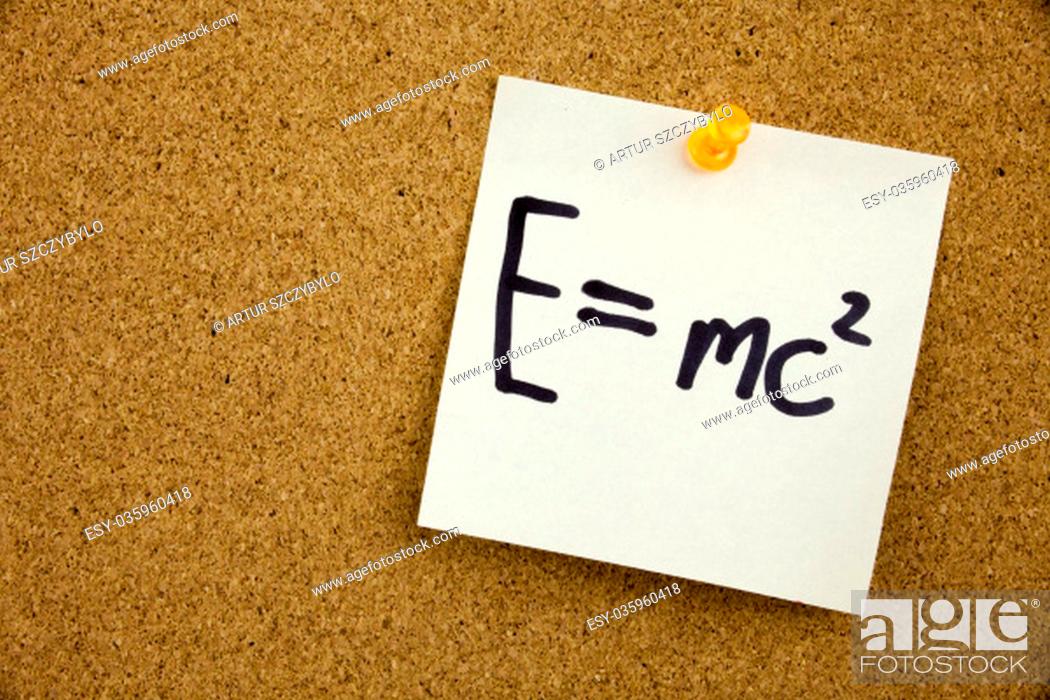 Stock Photo: EQUATION E EQUAL MC2 in black ext on a sticky note pinned to a cork notice board.