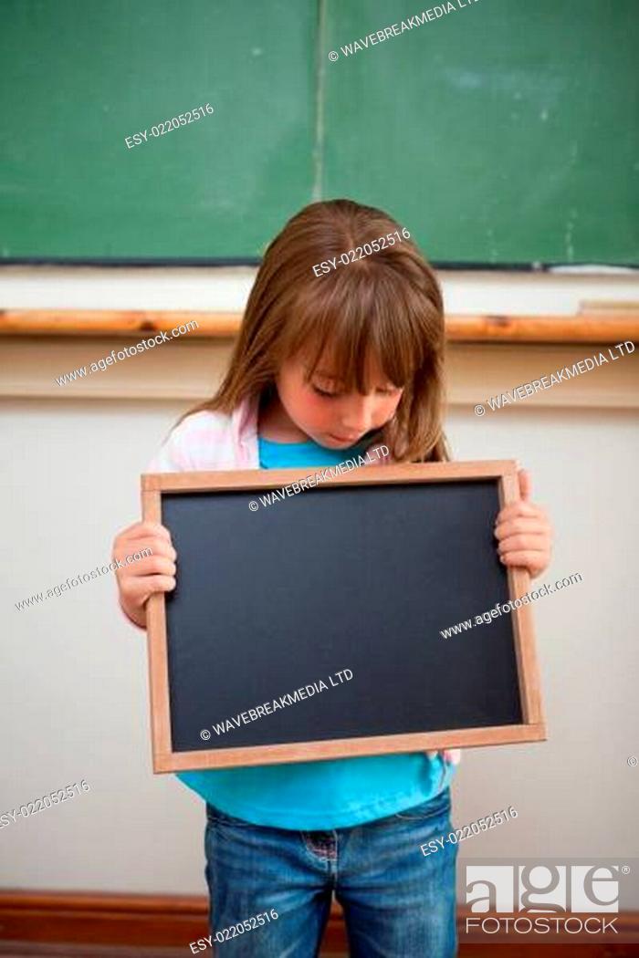 Stock Photo: Portrait of a girl looking at a school slate.