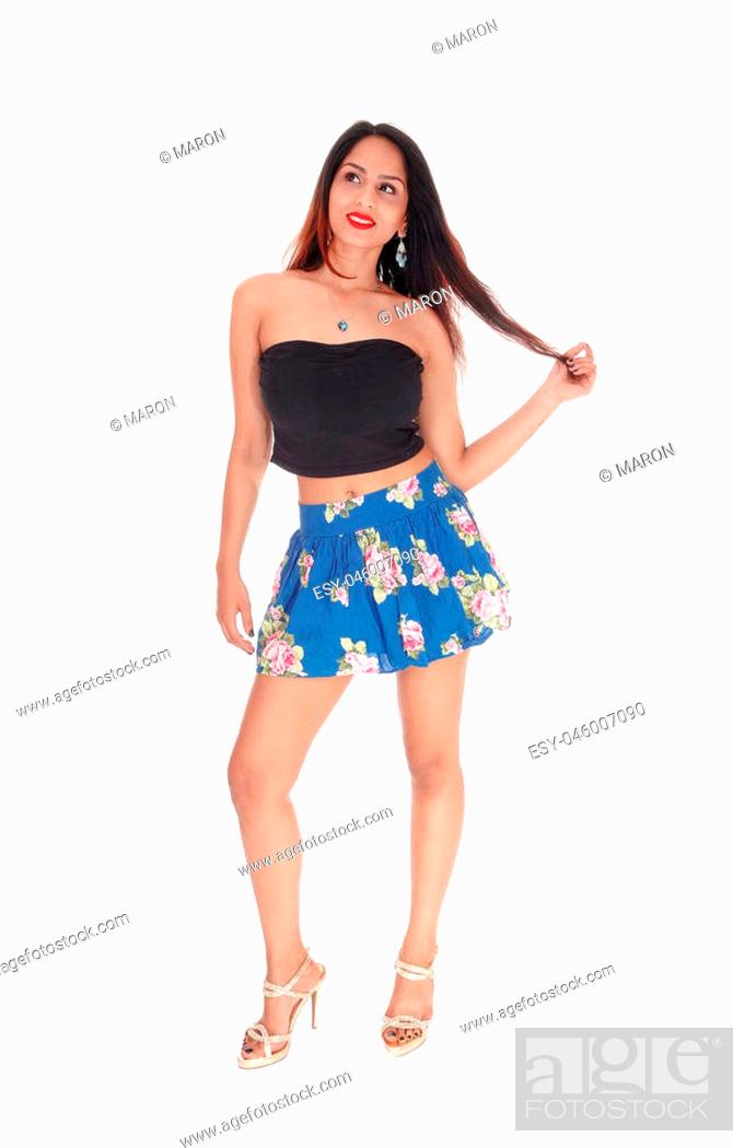 A beautiful East Indian woman standing in a short skirt and blackcorset,  holding her long hair, Stock Photo, Picture And Low Budget Royalty Free  Image. Pic. ESY-046007090 | agefotostock