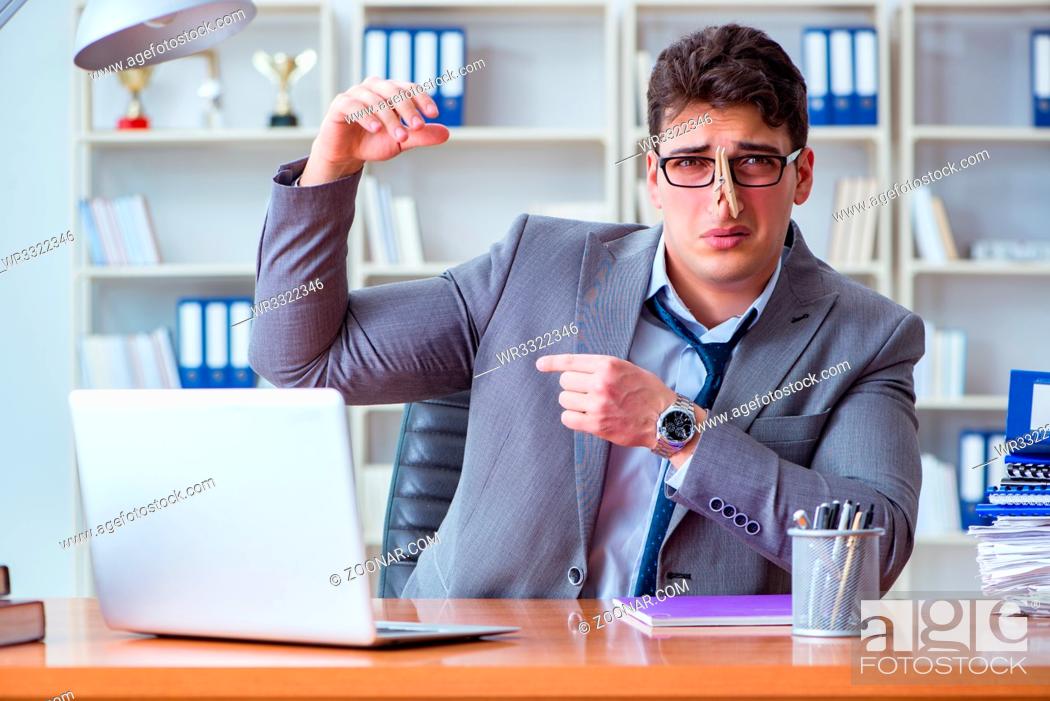 Stock Photo: Businessman sweating excessively smelling bad in office at workplace.