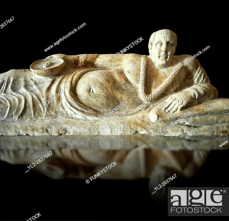 Stock Photo: Close up of an Etruscan Hellenistic style cinerary, funreary, urn cover with a man, National Archaeological Museum Florence, Italy , black background.