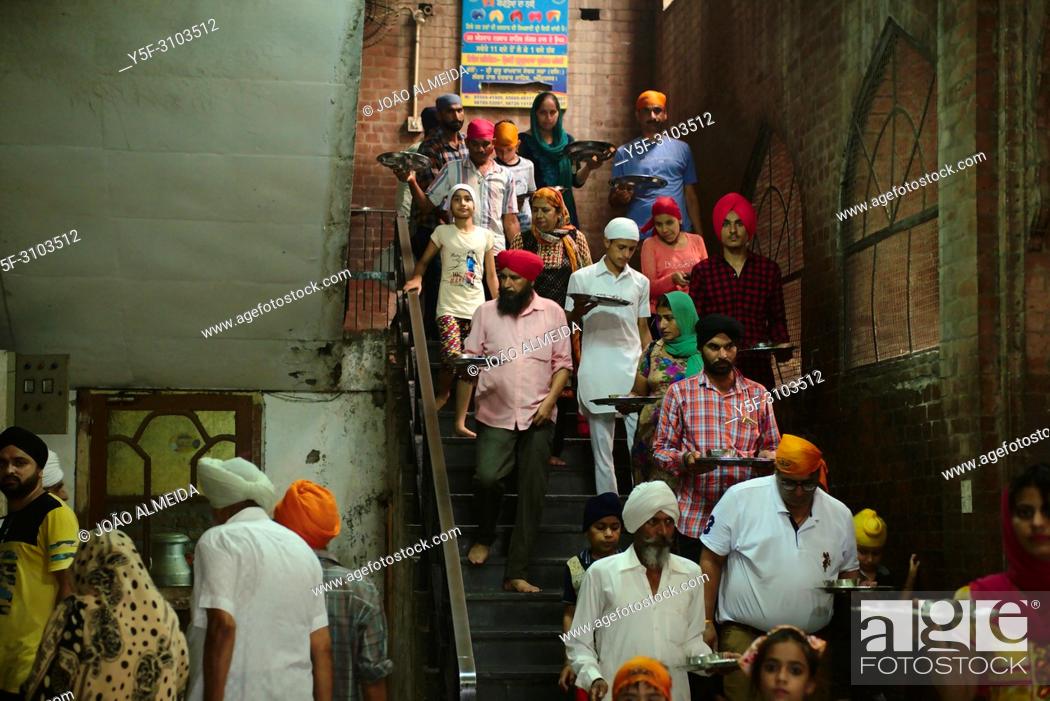 Stock Photo: The langar at Golden temple at Amritsar, where 60000 free meals are served everyday, and that mostly relies on volunteers to run it.