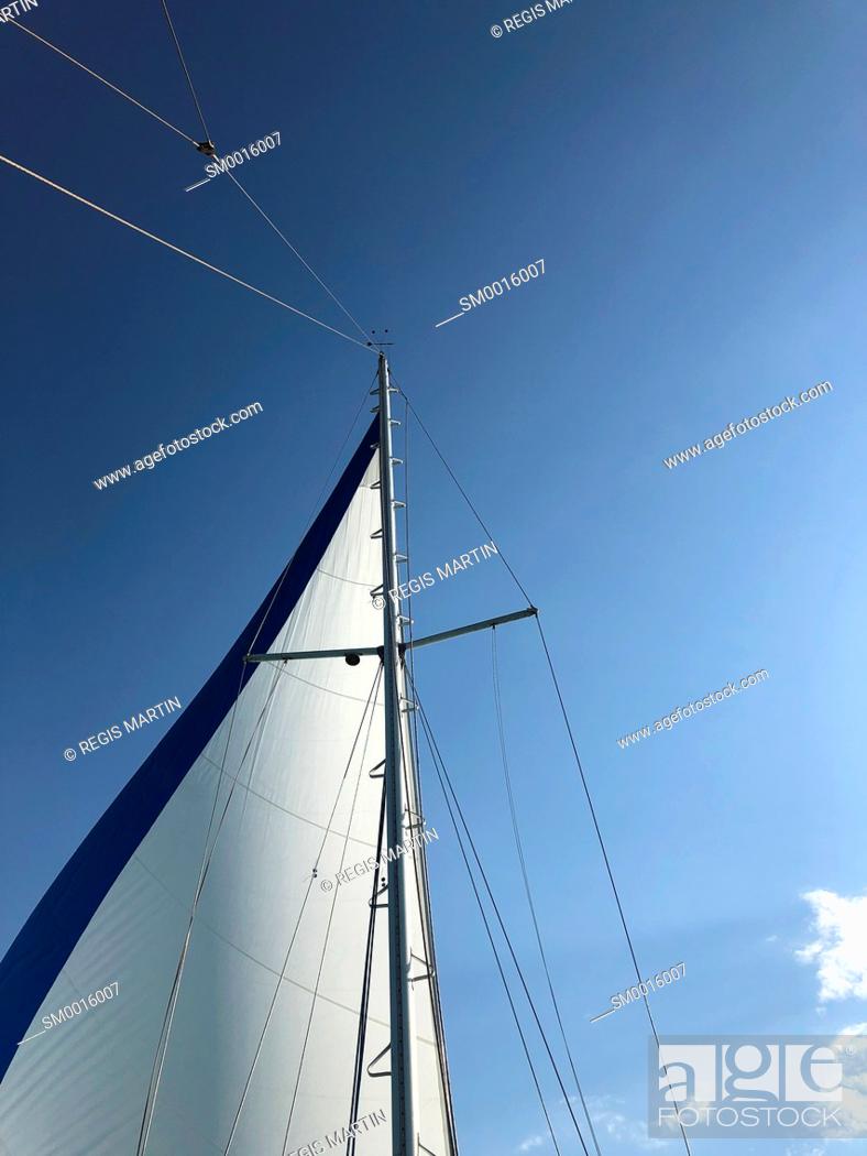 Stock Photo: Sail of a sailboat against the sky.