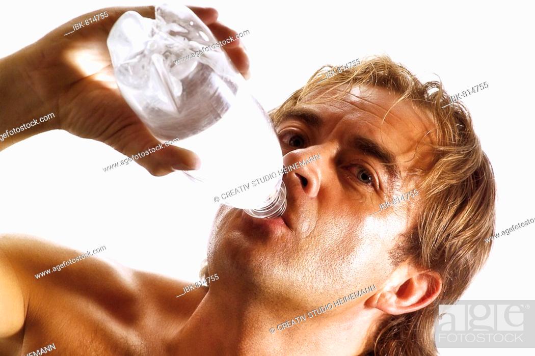 Stock Photo: Shirtless man drinking a bottle of water, bottled water.