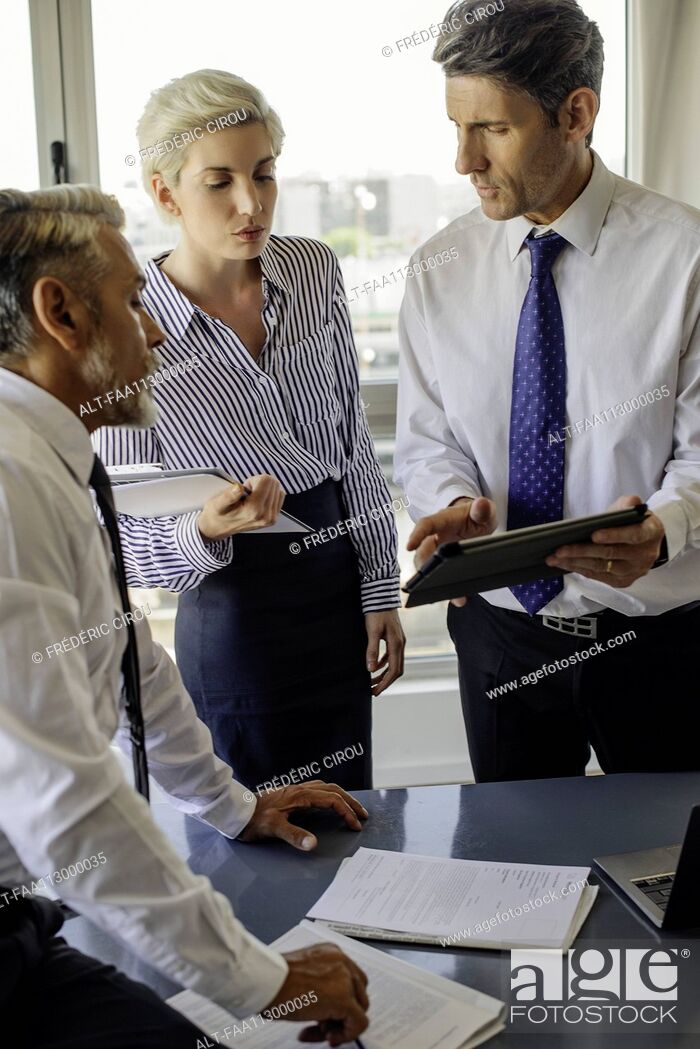Stock Photo: Colleagues working together in office.