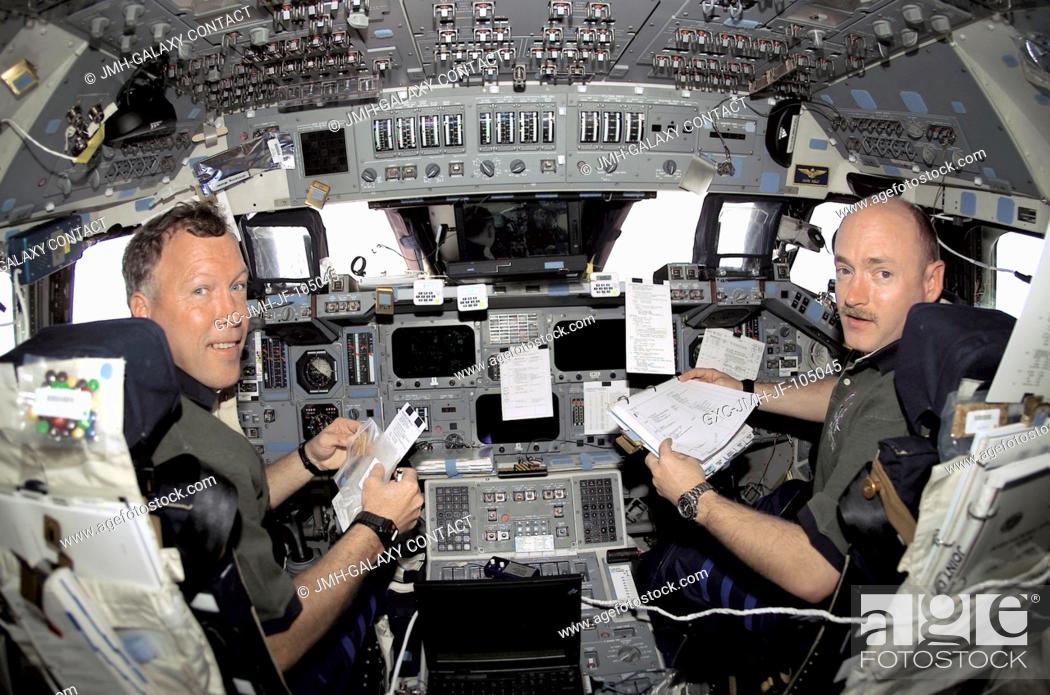 Stock Photo: Astronauts Dominic L. Gorie (background), STS-108 commander, and Mark E. Kelly, pilot, are in their respective stations during rendezvous operations with the.