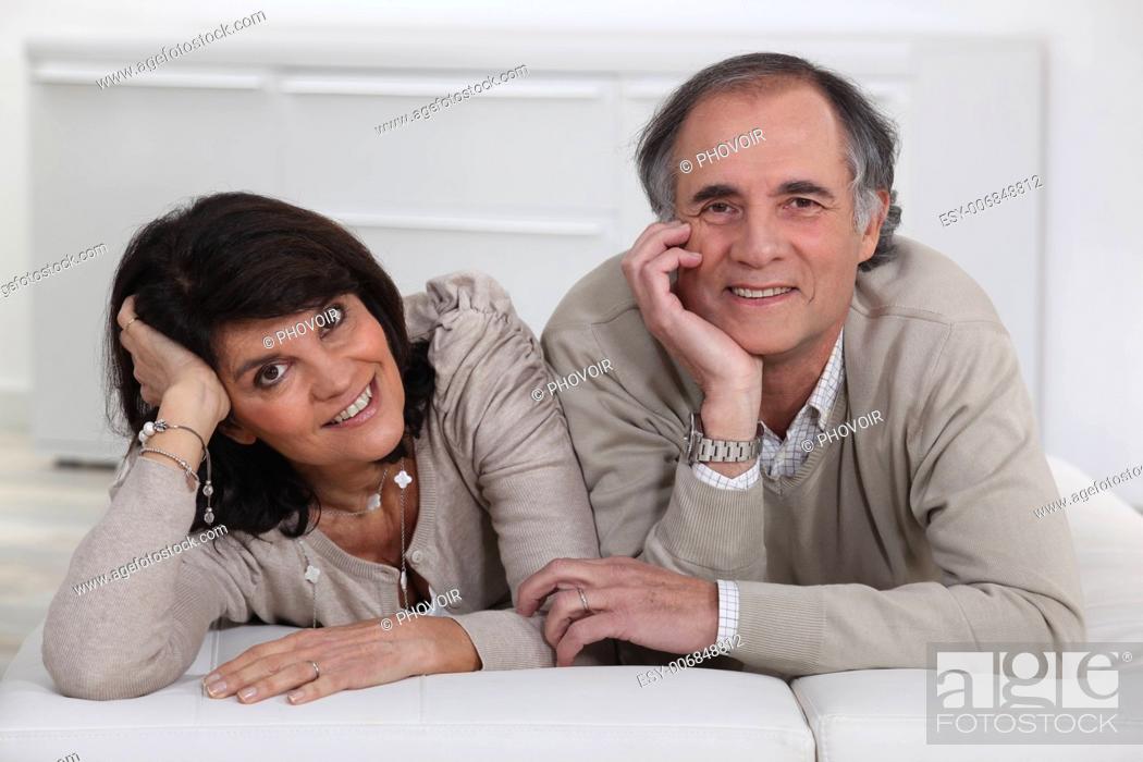 Stock Photo: Middle-aged couple lying on a futon.