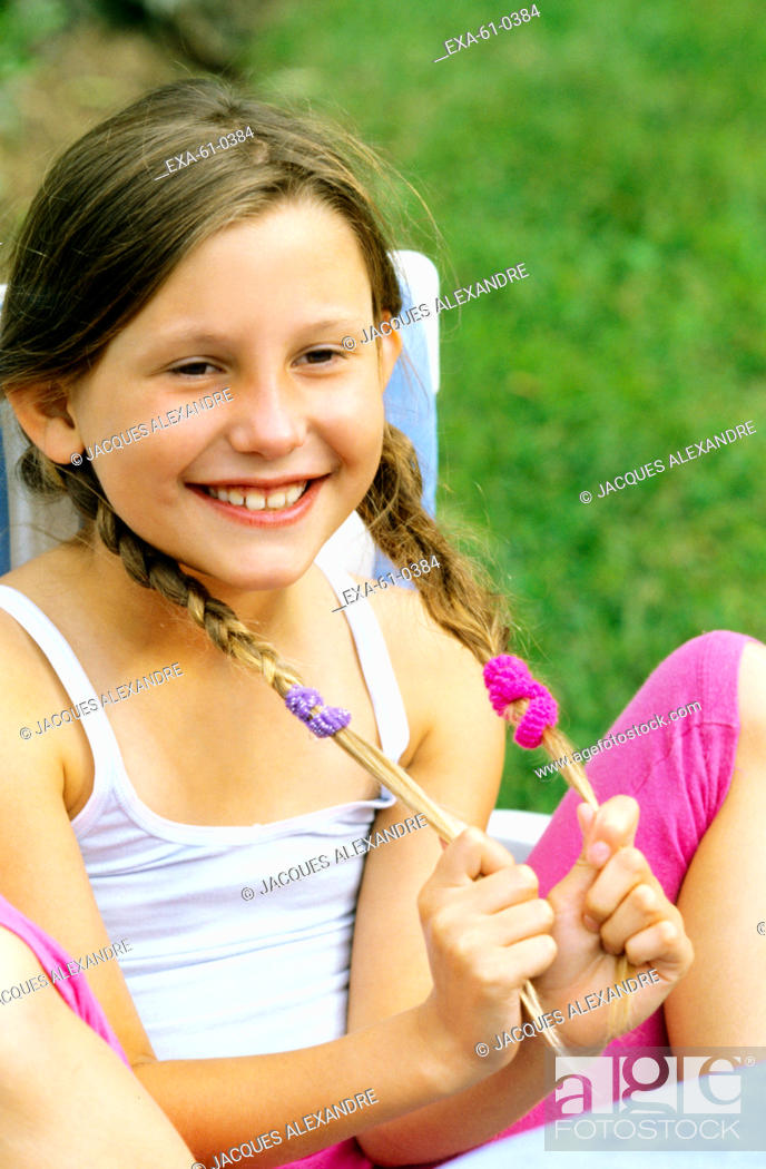 Stock Photo: Young girl smiling outdoors.