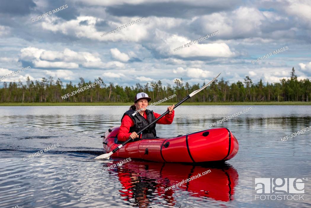 Stock Photo: Woman kayaking on lake.