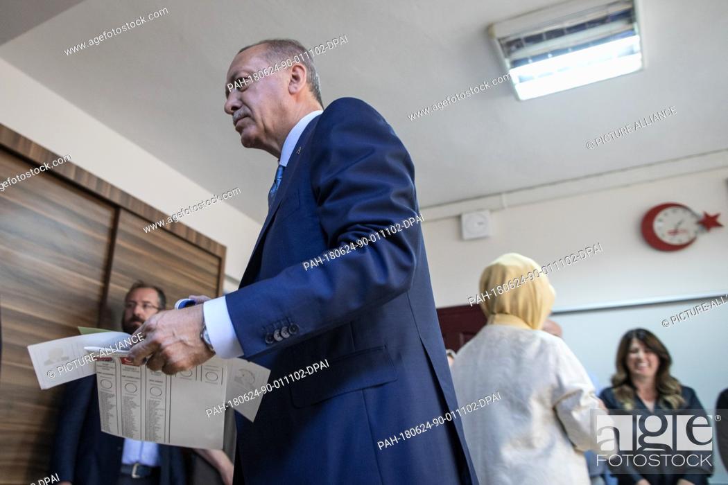Stock Photo: dpatop - Turkish President Tayyip Recep Erdogan holds his ballot papers to vote in Turkey's elections at a polling station, in Istanbul, Turkey, 24 June 2018.