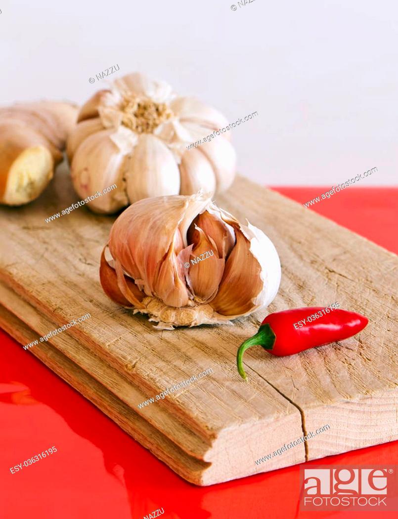 Stock Photo: A still life featuring garlic bulbs, chili pepper and ginger.