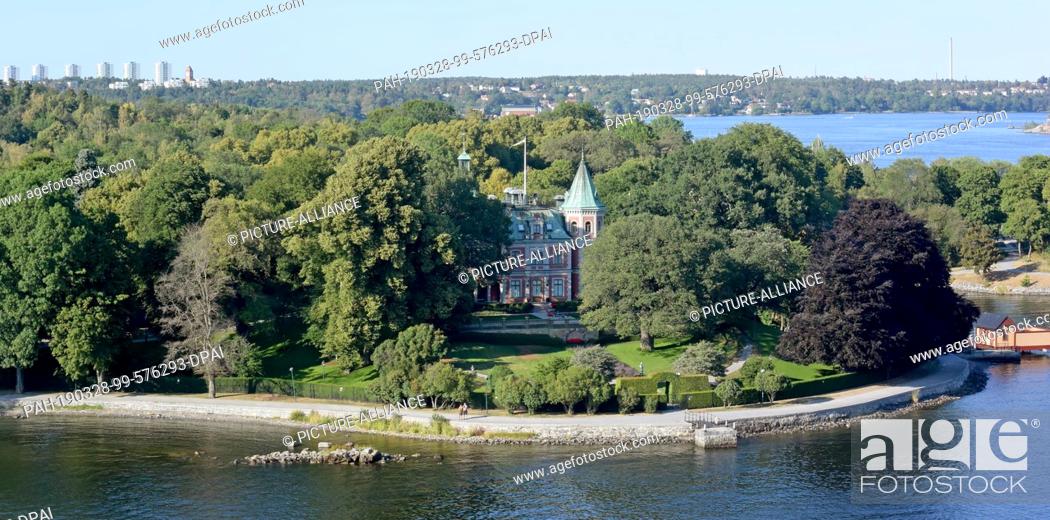 Stock Photo: 13 July 2018, Sweden, Stockholm: The castle-like Täcka Udden near the Swedish capital. Stockholm comprises 14 islands of a large archipelago in the Baltic Sea.