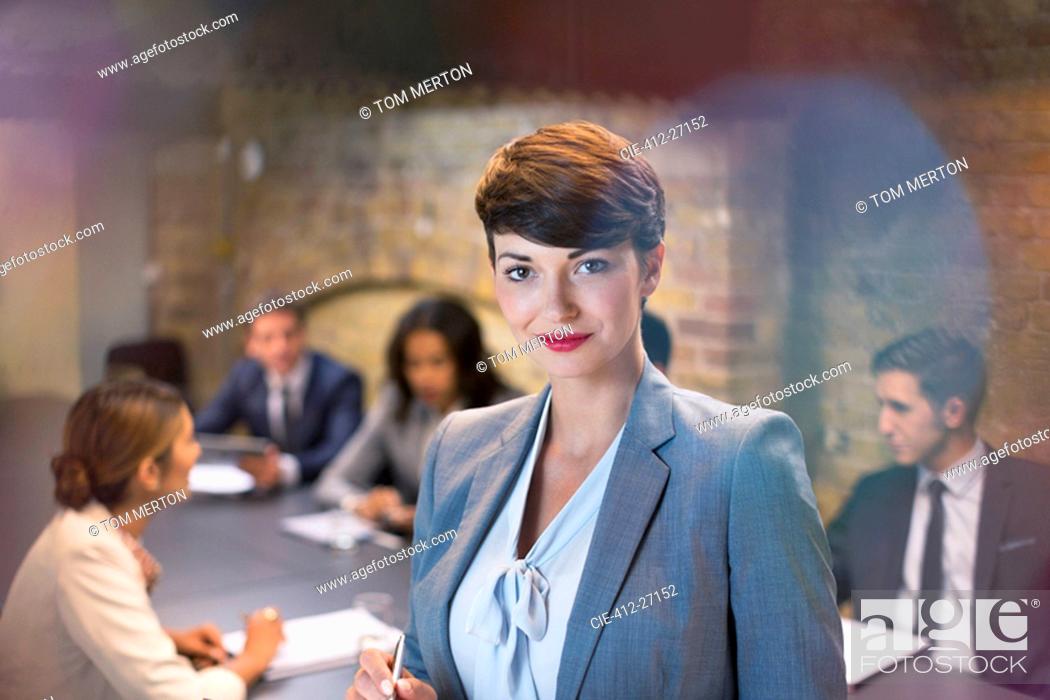 Stock Photo: Portrait confident businesswoman in conference room meeting.