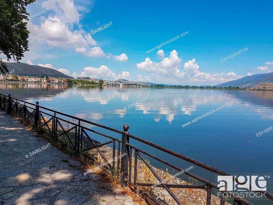 Photo de stock: Ioannina city and lake Pamvotis in spring season boat reflection of the clouds in the water green trees in greece.