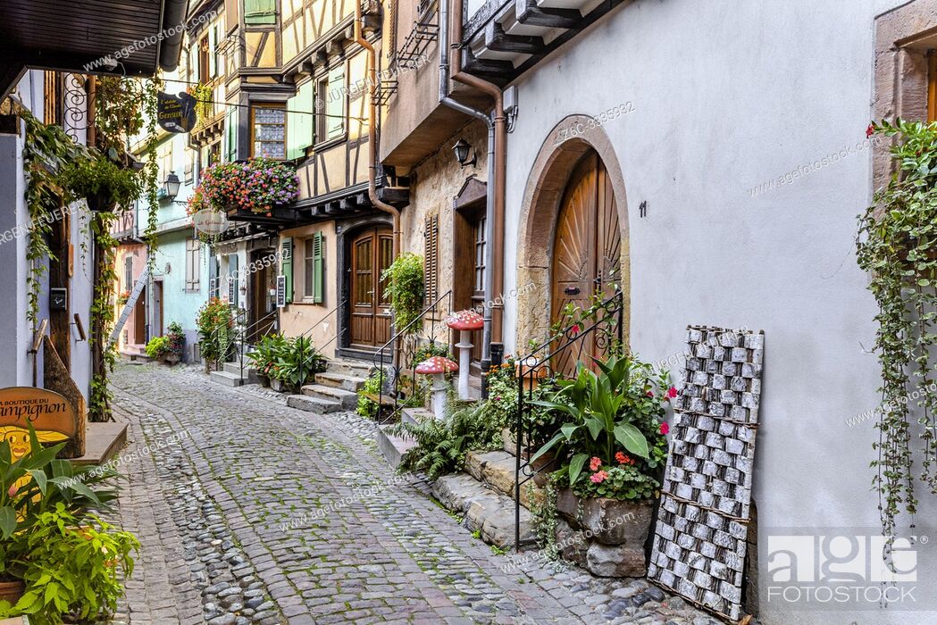 Stock Photo: houses in the small old village Eguisheim, Alsace, France, lane with timbered houses and flower decoration.