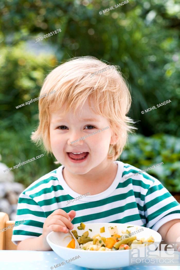 Stock Photo: Small boy eating vegetable soup.