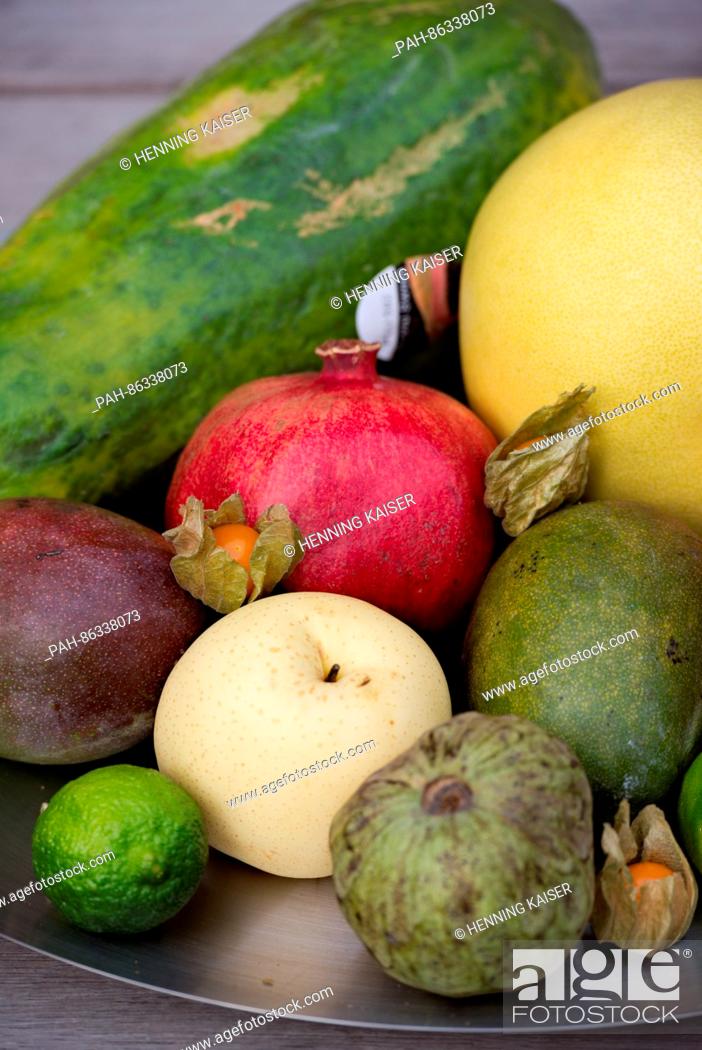 Stock Photo: A papaya, mango, nashi pear, physalis, pomelo, cherimoya, coconut and lime seen on a fruit plate in Cologne, Germany, 07 December 2016.