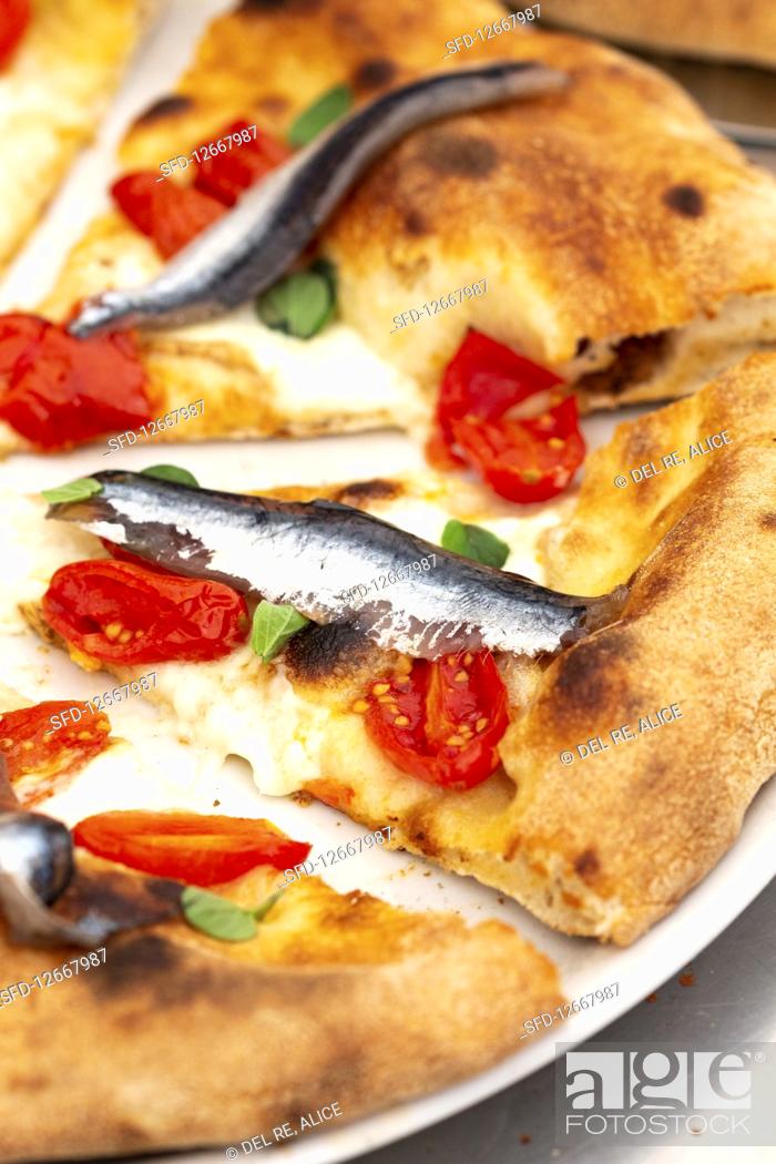 Stock Photo: Tomatoes and anchovies pizza (detail).