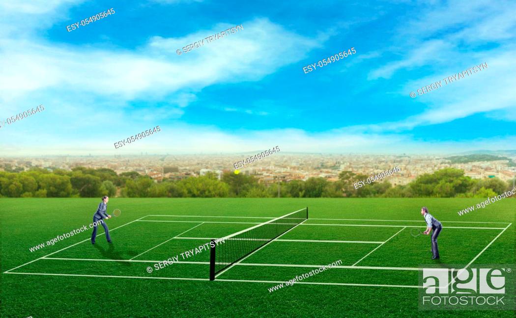 Stock Photo: Businessman and businesswoman playing tennis.