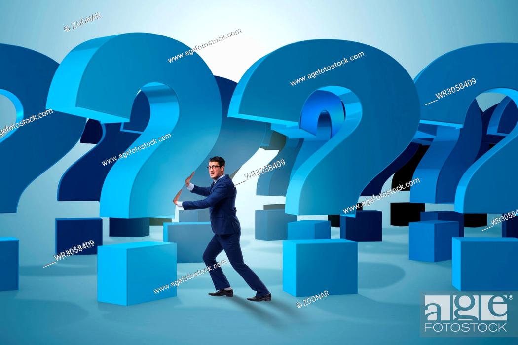 Stock Photo: Businessman in uncertainty concept with question marks.