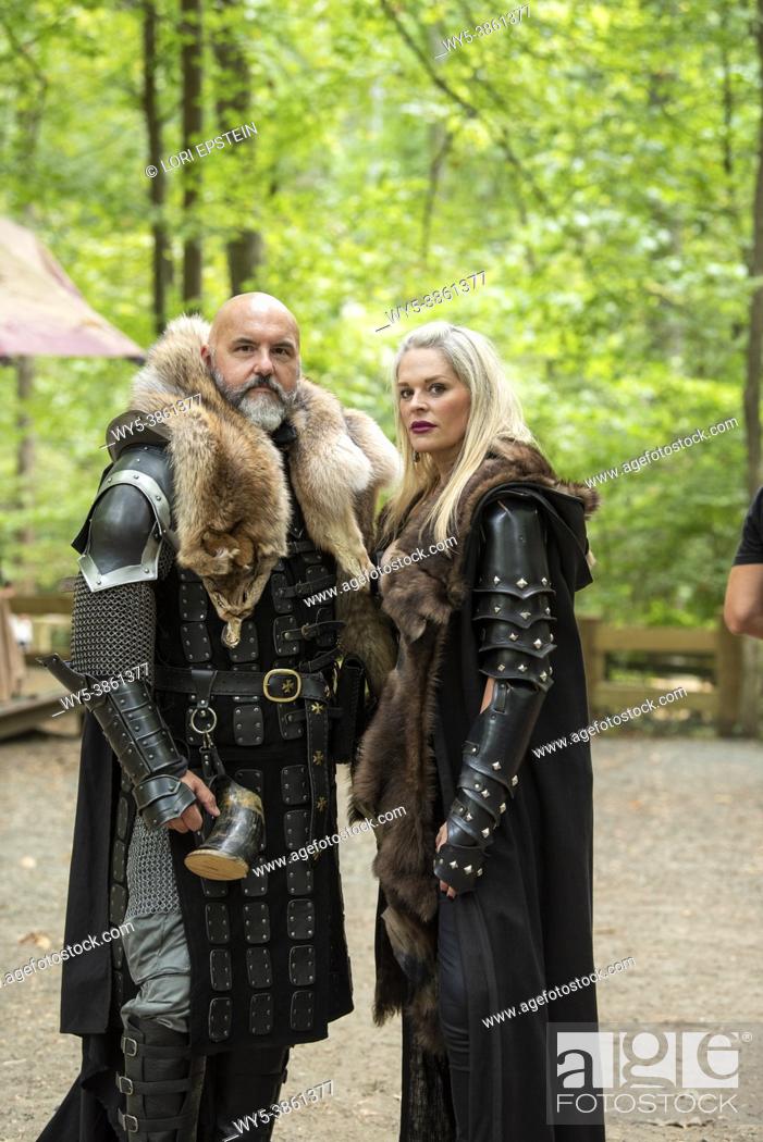Stock Photo: A husband and wife wearing medieval style costumes pose for the camera with stern looks on their faces.
