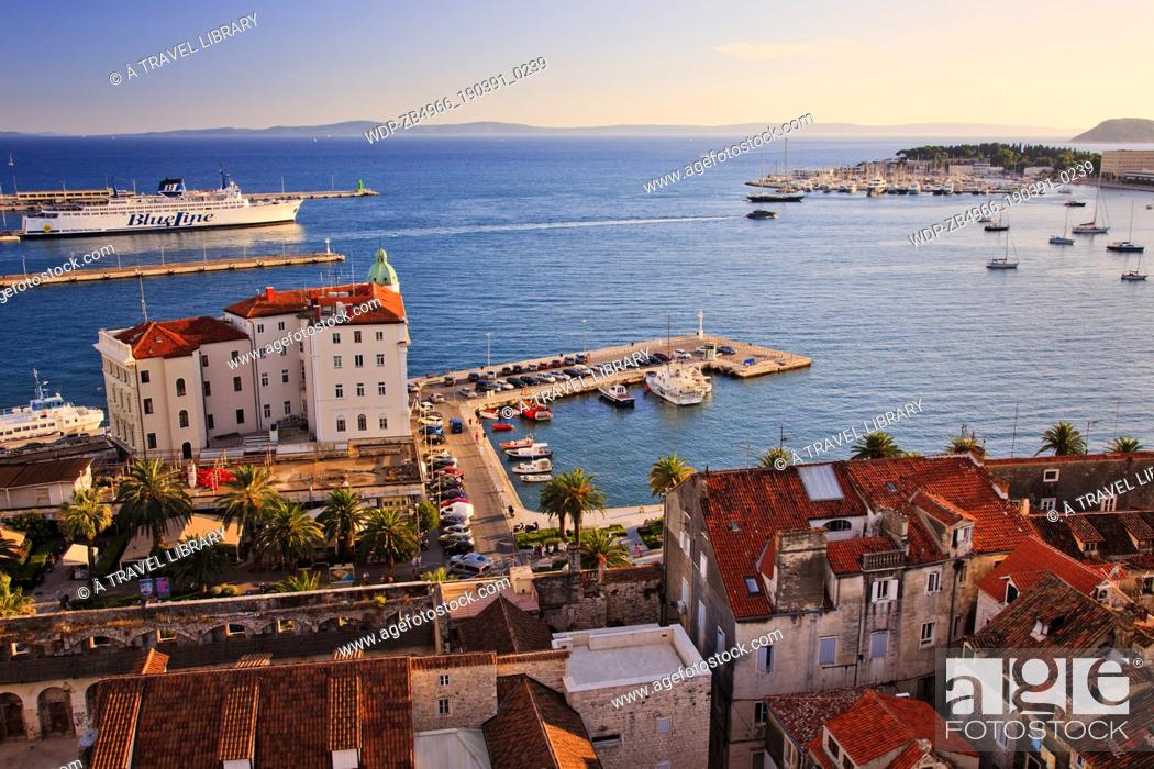 Stock Photo: The last of the summer sun sheds a warm glow over Split's waterfront and harbour. Split is Croatia's second largest city and is fast becoming a major tourist.