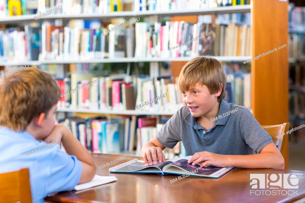 Stock Photo: Students reading together in library.