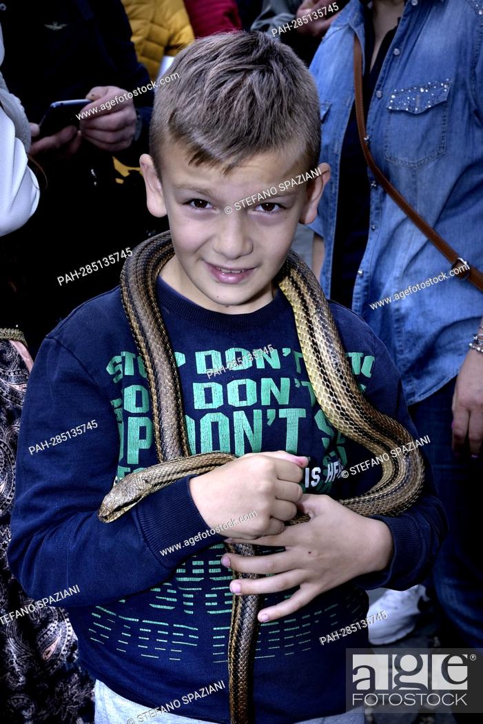 Stock Photo: After two years of interruption due to the pandemic, the procession of snakes in Cocullo takes place on 1 May 2022.Children of Cocullo with snakes in hand.