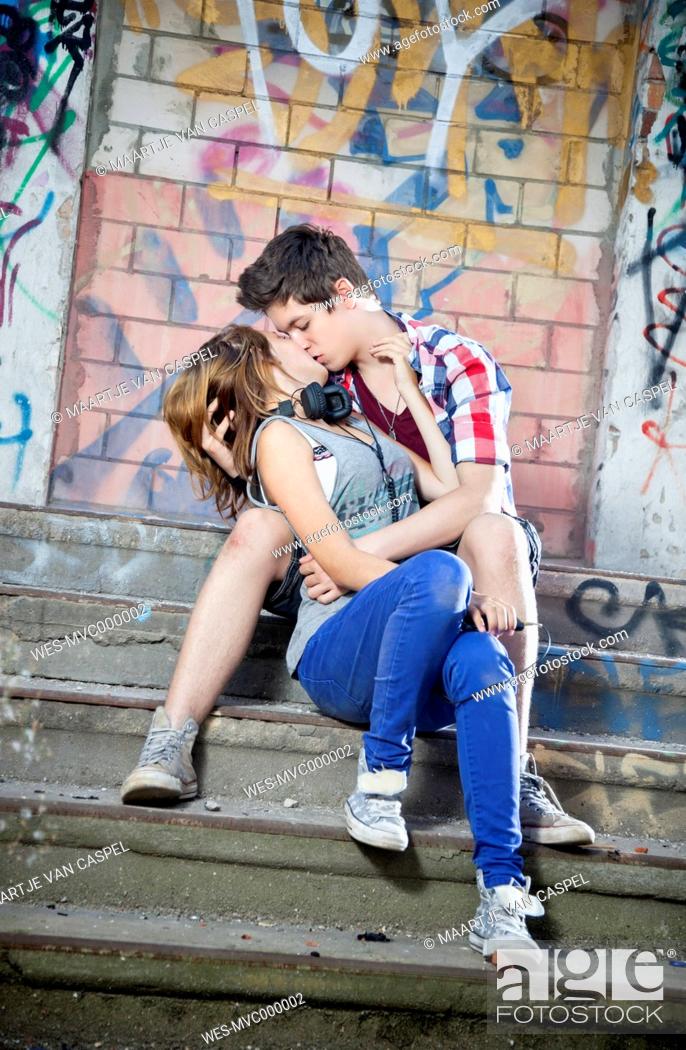 Stock Photo: Germany, Berlin, Teenage couple kissing each other.