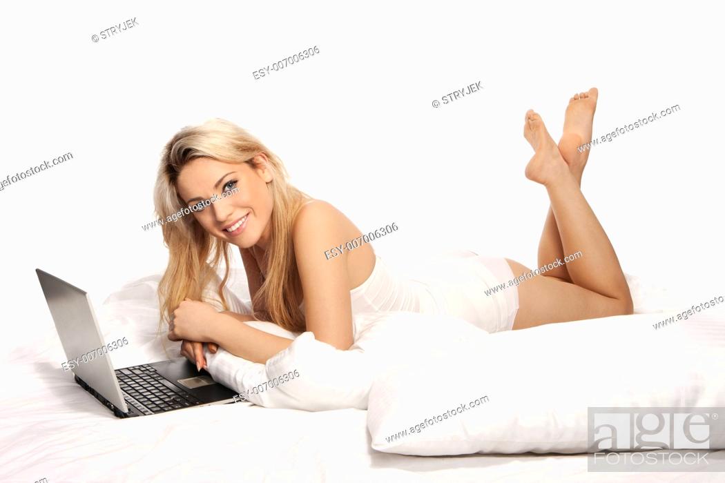 Blonde woman feet Beautiful Young Blonde Woman Lying On Her Stomach Kicking Her Feet In The Air Using A Laptop On A Stock Photo Picture And Low Budget Royalty Free Image Pic Esy 007006306 Agefotostock