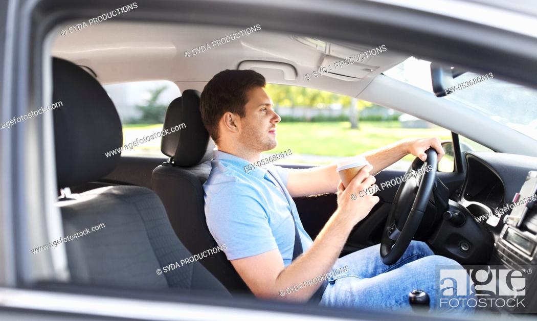 Stock Photo: man or driver with takeaway coffee cup driving car.
