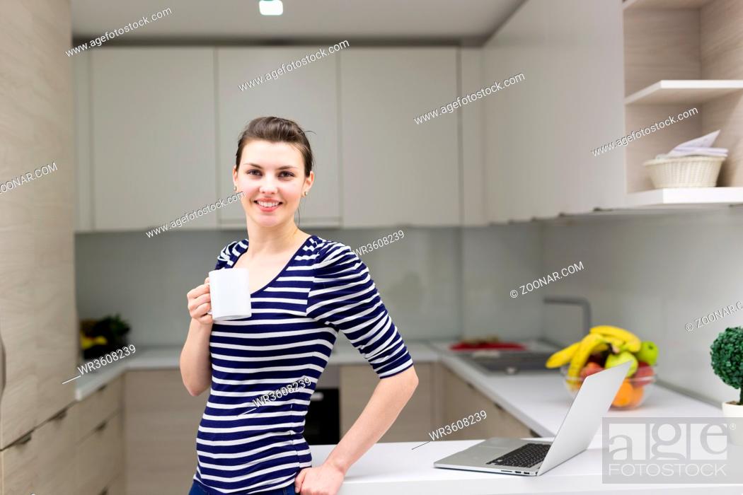 Stock Photo: Real Woman Using laptop At Home Drinking Coffee Enjoying Relaxing.