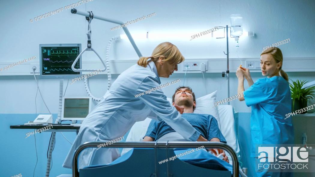Stock Photo: Hospital doctor and nurse trying to resuscitate a patient.