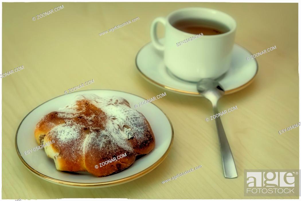 Stock Photo: Breakfast: a Cup of coffee and bun on the plate.