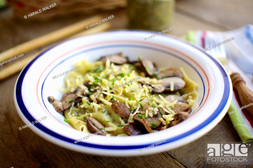 Stock Photo: Homemade kale and walnut pesto ravioli with mushrooms and vegan cheese and chives.