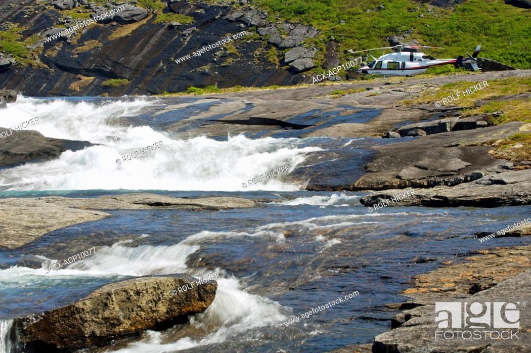 Stock Photo: Waterfall with a helicopter in the background in the Mealy Mountains in Southern Labrador, Newfoundland & Labrador, Canada.