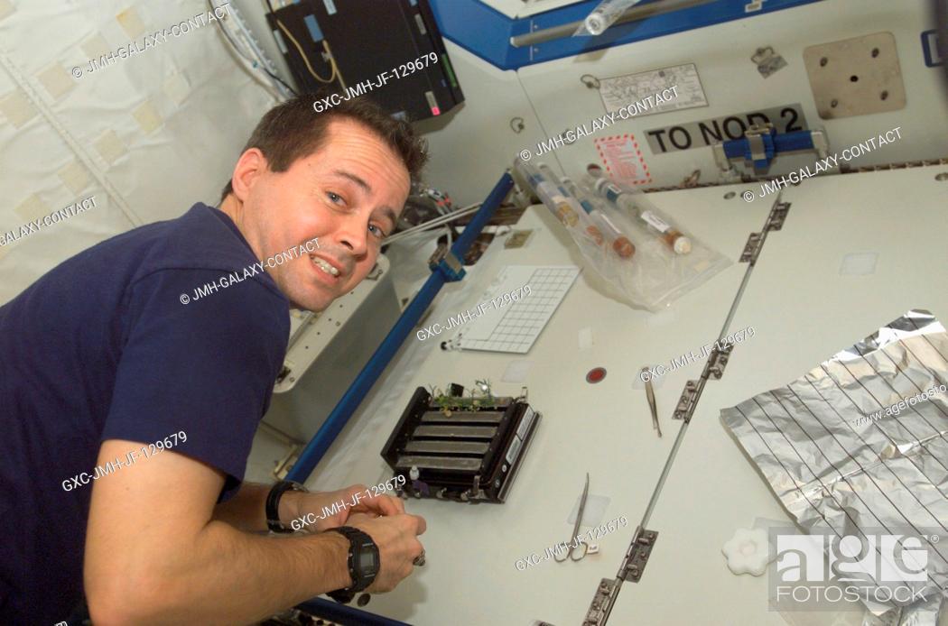 Stock Photo: Astronaut Daniel W. Bursch, Expedition Four flight engineer, works in the Destiny laboratory on the International Space Station (ISS).