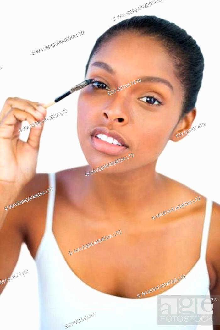 Stock Photo: Dark haired woman putting on mascara.