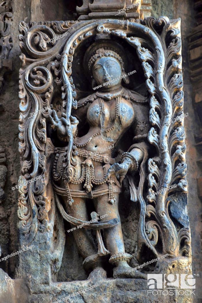 Stock Photo: Madanika or Dancing girl under Foliage. Hoysalesvara Temple, Halebid, Karnataka, 12th Century. Shiva temple.