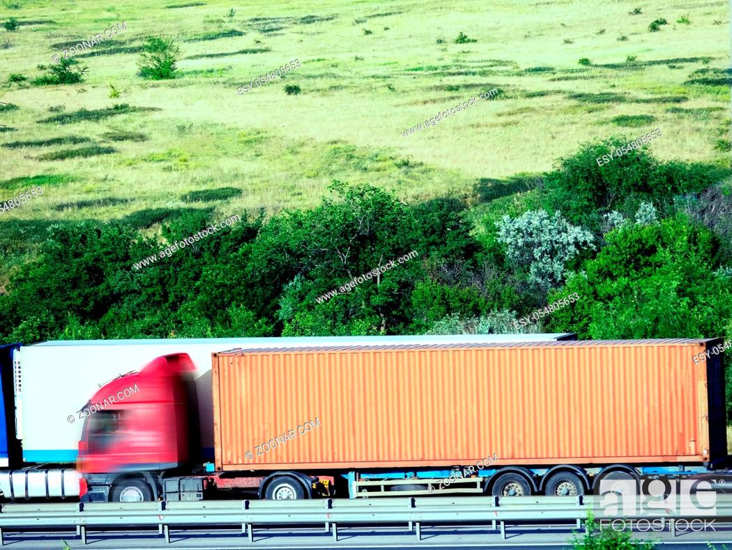Stock Photo: Blurred unrecognizable truck transport on road. Transport overpasses on the highway for the transport of orders and goods.