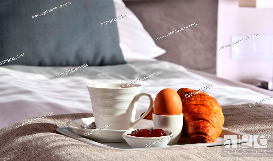Stock Photo: Breakfast on tray in bed in hotel room.