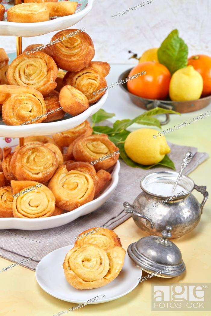 Stock Photo: Closeup of Italian pinwheel orange pastries, typical sweets made during the carnival period from fried puff pastry flavored with orange zest and honey.