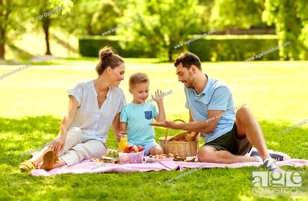Stock Photo: happy family having picnic at summer park.