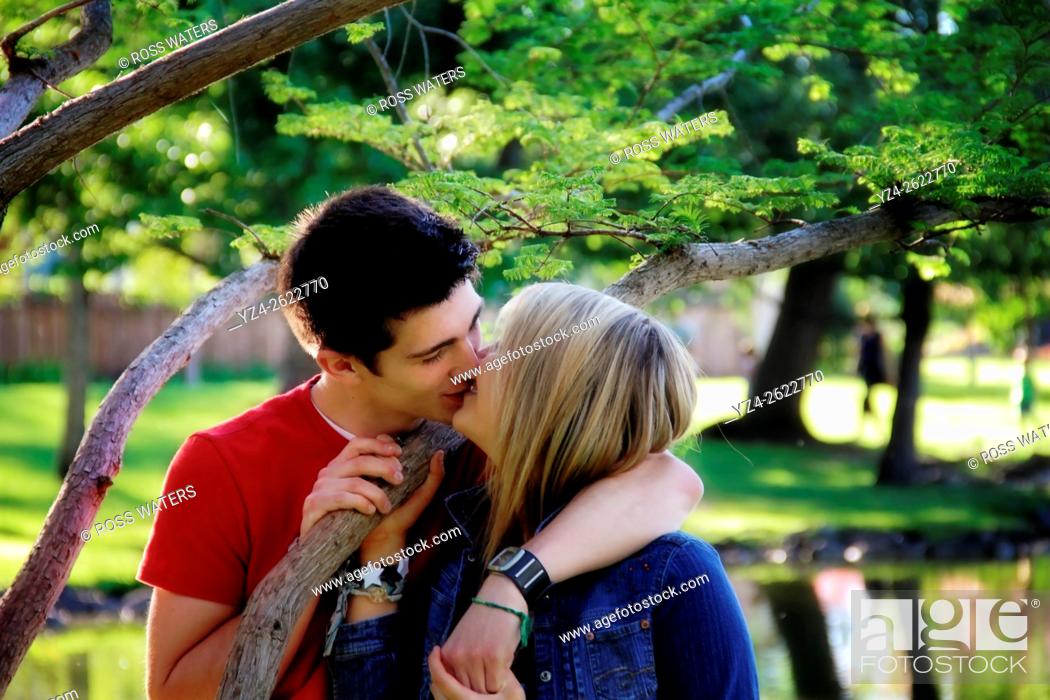 Stock Photo: Closeup of a young couple outdoors kissing.