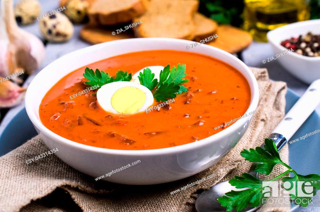 Stock Photo: Thick vegetable soup with cream and egg in a plate on the table. Selective focus.